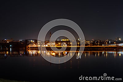 Dark cityscape with river and illuminated Stock Photo