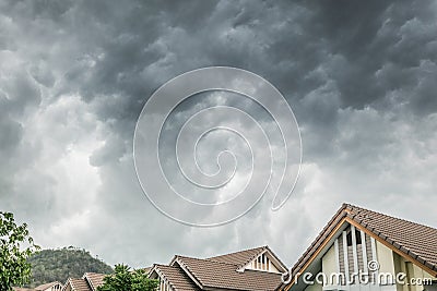 Dark clouds going to heavy rain over the house roof Stock Photo