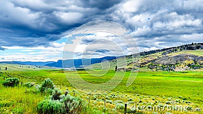 Dark Clouds hanging over the fertile farmland and rolling hills along Highway 5A near Nicola Lake, between Kamloops and Merritt Stock Photo