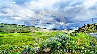 Dark Clouds hanging over the fertile farmland and rolling hills along Highway 5A near Nicola Lake, between Kamloops and Merritt Stock Photo