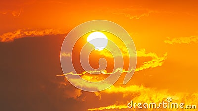 Dark clouds look like a crocodile with the sun and the orange sky Stock Photo