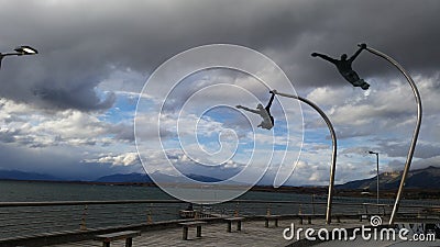 Dark clouds monument sculrpture man woman ocean Stock Photo