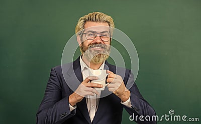 Dark coffee, bright future. Happy teacher hold coffee cup. Bearded man enjoy drinking coffee. Coffee break. School break Stock Photo