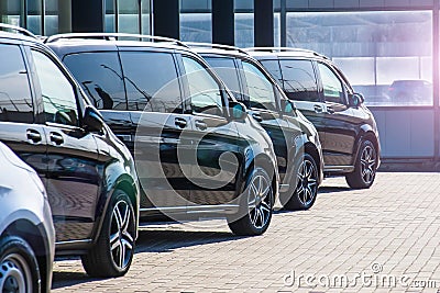 Dark colored passenger vans in a parking lot Stock Photo