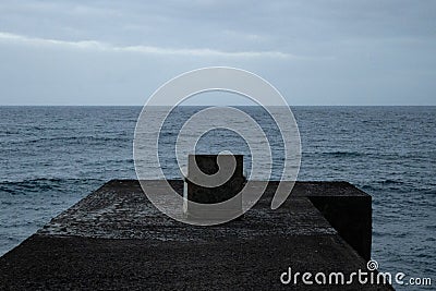 Dark concept of abandoned chair in stormy Ocean Stock Photo