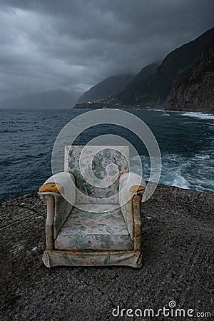 Dark concept of abandoned chair in stormy Ocean Stock Photo