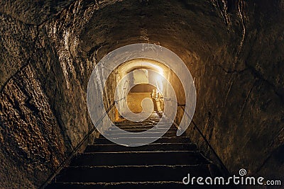 Dark corridor of old abandoned underground Soviet military bunker. Staircase goes down Stock Photo