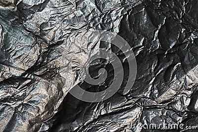 Dark crumpled aluminium foil texture background. Stock Photo