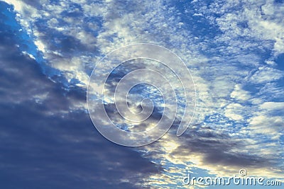 Dark Cumulus and light feathery clouds on the blue sky. Stock Photo