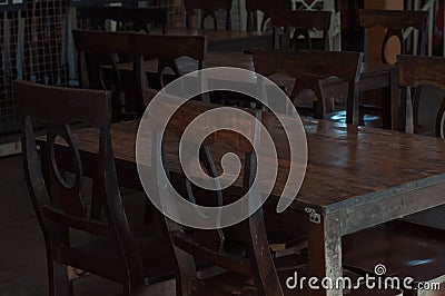 Dark dining table with wooden chair and vintage restaurant Stock Photo