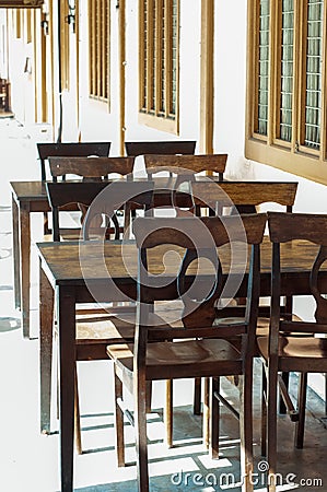 Dark dining table with wooden chair and vintage restaurant Stock Photo