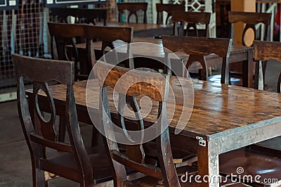 Dark dining table with wooden chair and vintage restaurant Stock Photo