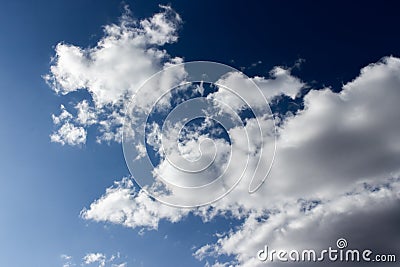 Dark evening sky with white clouds. Twilight blue sky with puffy cumulus clouds, heavenly landscape. Background wallpaper backdrop Stock Photo