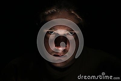 Dark evil face on black background Stock Photo