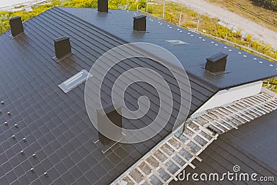 dark gray roof of an industrial building made of metal. Corrugat Stock Photo