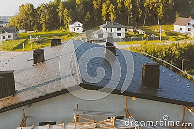 dark gray roof of an industrial building made of metal. Corrugat Stock Photo