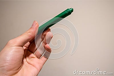 Dark Green Crayon in Hand Stock Photo