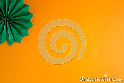 Dark green decorative paper cigar on an orange textured background Stock Photo
