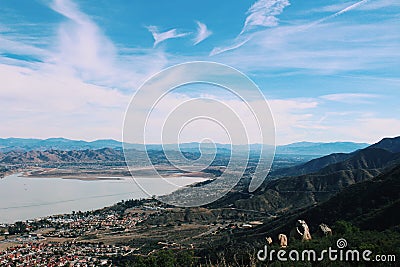 Dark green hills next to a lake Stock Photo