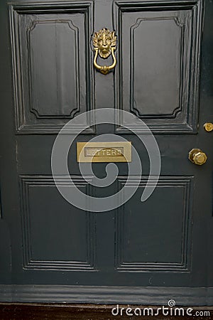 Entrance door brass mail slot letters lion Stock Photo