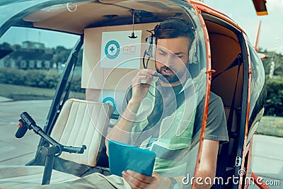 Dark-haired resolute man having connection with operator Stock Photo
