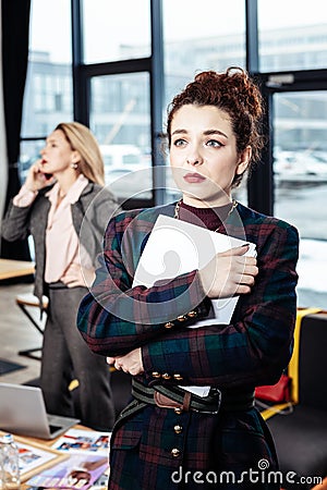 Dark-haired secretary leaving strict boss with negative emotions Stock Photo