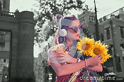 Dark-haired student feeling pleased after receiving sunflowers from boyfriend Stock Photo