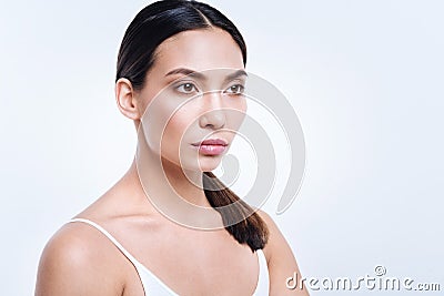 Dark-haired woman with swarthy complexion posing half-turned Stock Photo
