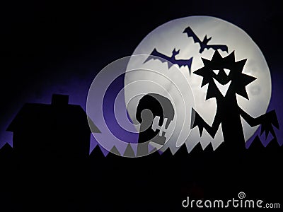 Dark Halloween season background with moon in the background and scary creatures silhouettes. Alien scull, bats, and funny monster Stock Photo