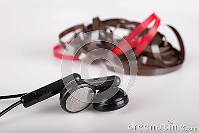 Dark headphones and magnetic tape with call recordings. Eavesdropping accessories Stock Photo