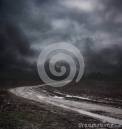 Dark Landscape with Dirty Road and Moody Sky Stock Photo