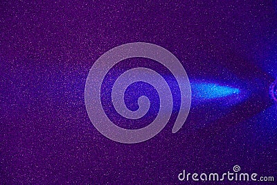 On a dark lilac structural fine-grained background, a light blue beam of light Stock Photo