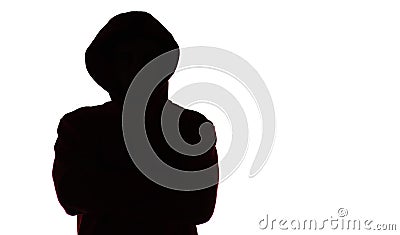 Dark male silhouette in casual sportswear with a hood, figure of a guy hiding his face, concept of privacy and confidentiality Stock Photo