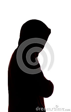 Dark male silhouette in casual sportswear with a hood, figure of a guy hiding his face, concept of privacy and confidentiality Stock Photo