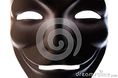 Dark mask isolated on white. Close-up. Smile symbol of an anonymous hacker. Shooting a subject in a dark key Stock Photo