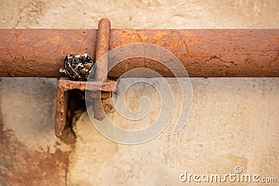 Dark molten piece of plastic on industrial pipe Stock Photo