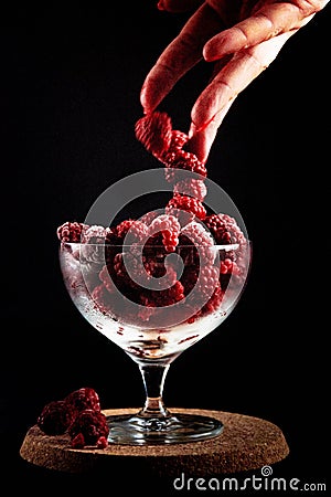 Frozen raspberries with powdered sugar. Stock Photo