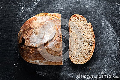 Dark mood and tone Home Cooking Homemade Organic rustic Sourdough bread on black background with copy space Stock Photo