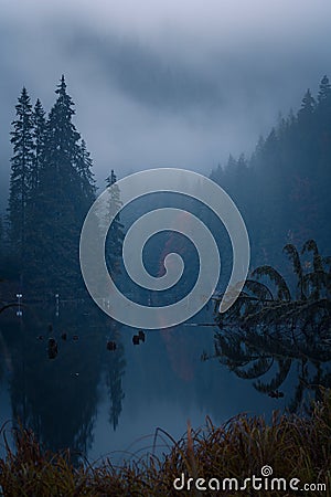 Dark moody view of the Red Lake Lacul Rosu in Romania Stock Photo