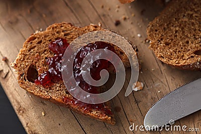 Dark multigrain bread whole grain and jam fresh baked on rustic Stock Photo