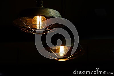 A modern lamp light shines in the black room with copy space Stock Photo