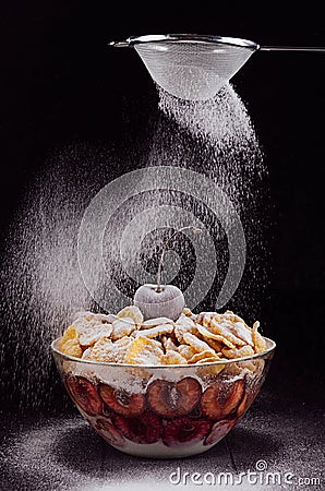 Dark perfect refined dessert with ripe cherry and wave falling powdered sugar. Stock Photo