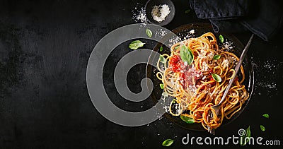 Dark plate with italian spaghetti on dark Stock Photo