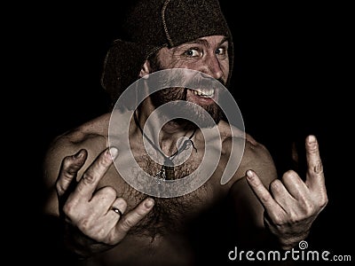 Dark portrait of scary evil sinister bearded man with smirk, shows sign of heavy metal. strange Russian man with a naked Stock Photo