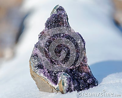 Dark purple Amethyst Quartz Druse Geode from Uruguay on white snow Stock Photo