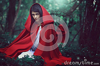 Dark red riding hood in a surreal forest Stock Photo