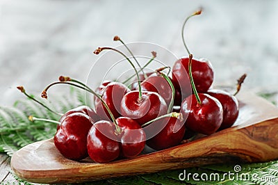 Dark red ripe large cherries on a wooden table, selective focus. Close up. Copy space Stock Photo