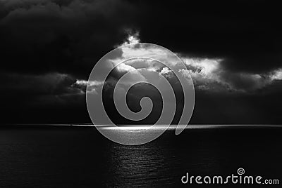 Dark Seascape with Black Sea and Sky and One Beam of Light Stock Photo