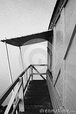 Dark shot of old stairs and stair railing Stock Photo