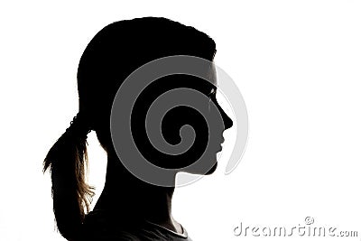 Dark silhouette profile of a young girl on a white background, concept of anonymity Stock Photo